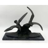 An Art Deco bronze effect study of flying birds signed M Font, France, on a black marble base, 12.