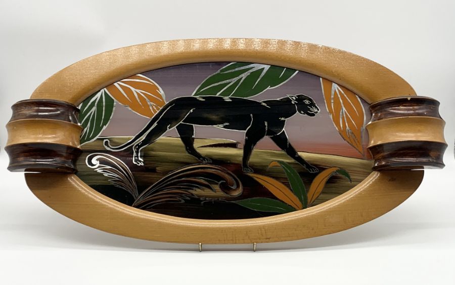 An Art Deco tray with back painted glass panel depicting a panther signed Dope