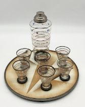A German Art Deco lacquered ceramic geometric pattern drinks tray with ball feet along with cocktail