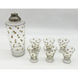An Art Deco glass cocktail set including shaker and 6 glasses in yellow polka dot pattern in