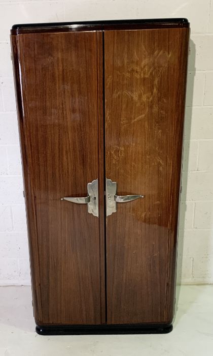 A rosewood Art Deco shelved wardrobe or storage cupboard with chrome handles and inlaid edges to