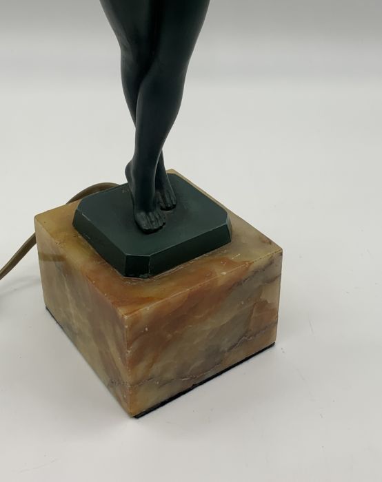 A green patinated Art Deco lamp in the form of a nude lady holding aloft a flame shaped glass - Image 3 of 5