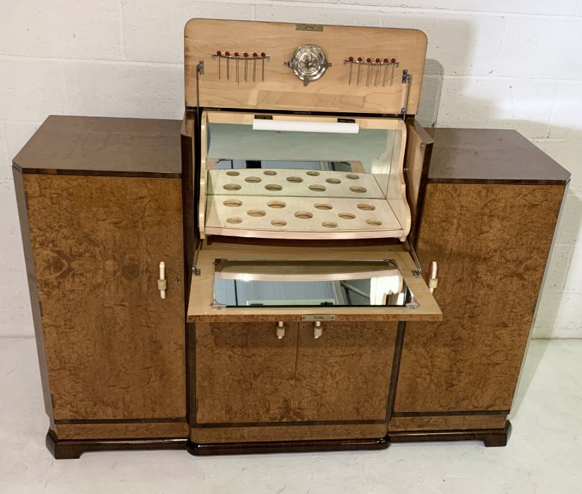 An Art Deco Amboyna cocktail cabinet with lift up top containing original mirror, juicer and - Image 7 of 7
