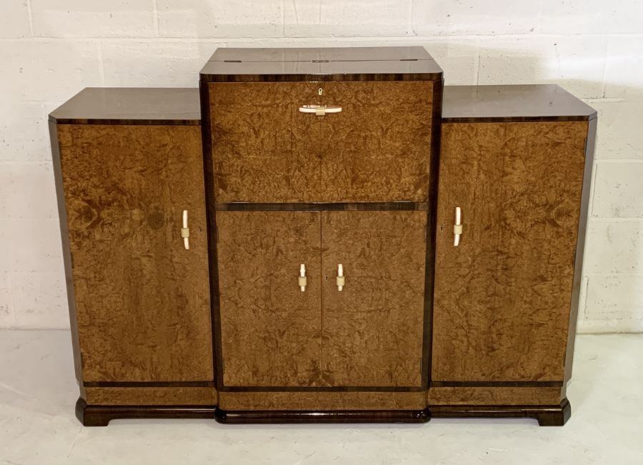 An Art Deco Amboyna cocktail cabinet with lift up top containing original mirror, juicer and