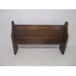 An antique church pew, length 152cm, height 98cm.