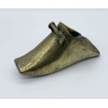 An Eastern brass stirrup