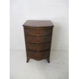 A walnut veneered bow fronted chest of four drawers