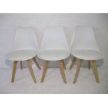 Three white M Milo chairs.