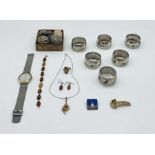 A collection of items including a Cartier clip, David Anderson brooch, Skagen watch, "dummy" eggs,