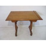 An occasional table, one side damaged but present.