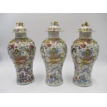 Three matching 19th century Chinese Famille Rose lidded vases depicting five-toed dragons - A/F