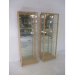 A pair of glass display cabinets