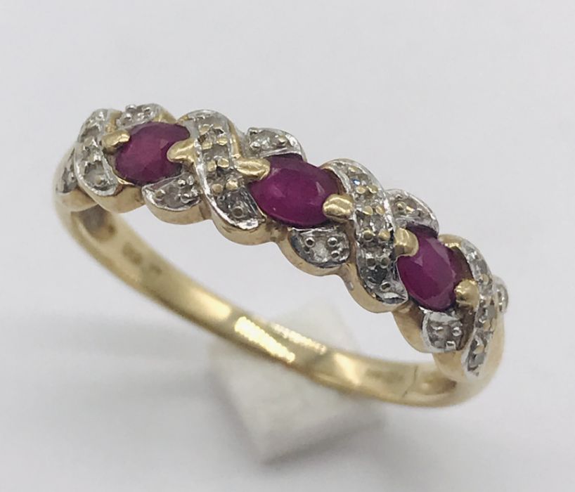 A 9ct gold half eternity style ring set with diamonds and rubies