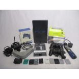 An unboxed Sony PlayStation 2 console with power cables, four controllers, eight games, controller