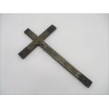 A wooden crucifix, with embossed metal decoration.