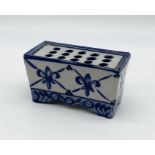 A ceramic flower brick with blue and white design