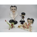 A collection of three boxed Betty Boop figurines including Classic Pose, Betty Leg Up, Betty Sun-
