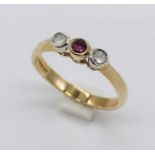 A 9ct gold three stone ring set with diamonds and ruby