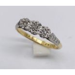 An 18ct gold and platinum illusion set diamond three stone ring