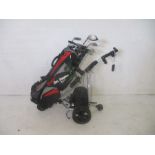 A selection of golf clubs in Ben Sayers carry bag, along with a motorised golf trolley - clubs