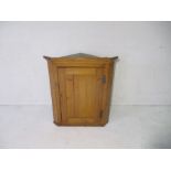 A pine corner cupboard, height 93cm.