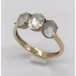 A 9ct gold three stone ring set with white topaz