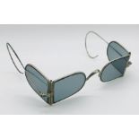 A pair of SCM sunglasses with blue glass front and hinged side lenses in case