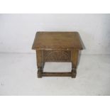 An antique style sewing box in the form of a joint stool.