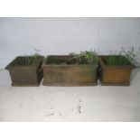 Three terracotta garden planters.