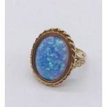 A 9ct gold ring set with a large synthetic opal