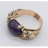 A 14ct gold colour change cabochon ring set with diamonds to the shoulders
