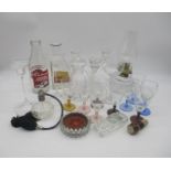 A collection of glass items including an oil lamp, Cadbury's bottle, perfume bottle etc.
