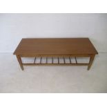 A mid-century teak coffee table with ladder shelf underneath