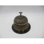 An ornate embossed antique desk bell.