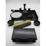 A collection of ebony dressing table pots, hand mirror etc.