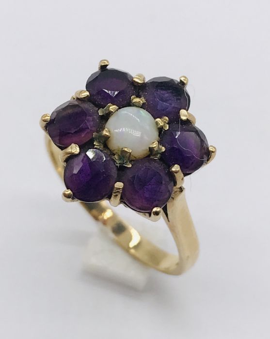 A 9ct gold cluster ring set with garnets and opal