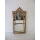 A wooden framed gothic mirror