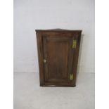 An antique Georgian oak hanging wall cupboard