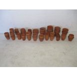 A quantity of various sized terracotta pots.
