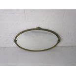 A brass framed oval bevel edged mirror.