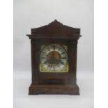 A 20th century oak cased mantle clock. with brass face.