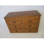 An antique pine chest of four drawers with ivory escutcheons