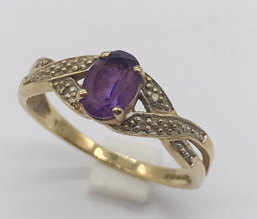 A 9ct gold dress ring set with amethyst and diamonds