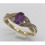 A 9ct gold dress ring set with amethyst and diamonds