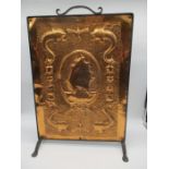 A copper and wrought iron Arts and Crafts fire screen, with hammered decoration depicting a