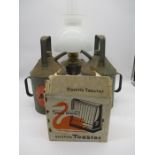 An assortment of vintage items including a brass oil lamp along with two Aladdin Pink paraffin cans,