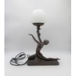 An Art Deco style lamp, in the form of a lady.