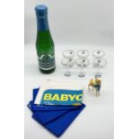 A collection of Babycham related items including money bank in the form of an oversized bottle,