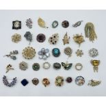 A collection of various vintage brooches