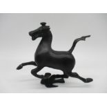 A bronze figure of a running horse.